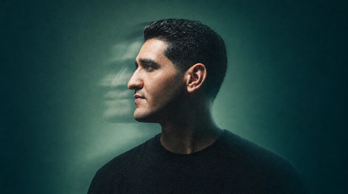 Portrait of Mohamed Rabie in profile against a deep green background